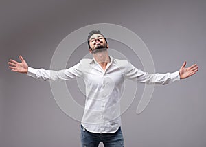 Man showing relieved gesture with spread arms photo