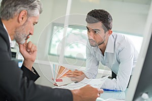 Man showing samples to coleague