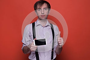 Man showing smartphone with blank screen and thumbing up