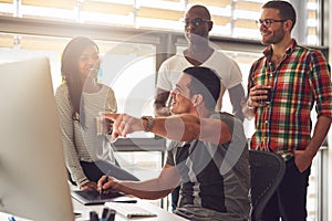 Man showing something on his computer to a group