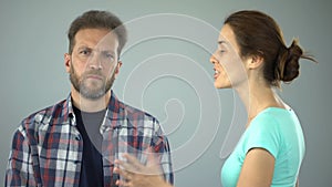 Man showing stop sign to annoyed wife who constantly screaming and complaining