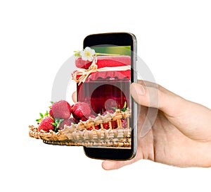 Man is showing strawberries through mobile phone