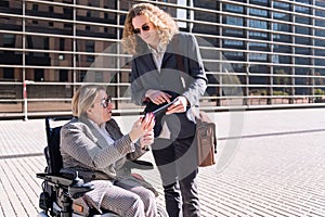 man showing tablet to business woman