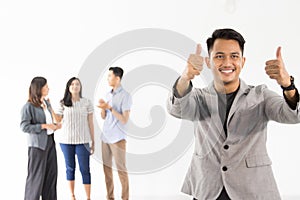 Man showing thumb up in front of his team
