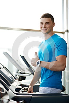 Man showing thumbs up near the treadmill