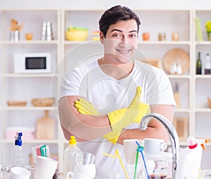 Man showing thumbs up washing dishes