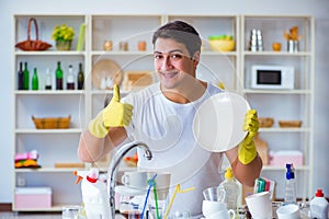 The man showing thumbs up washing dishes