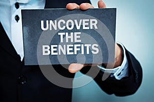 Man showing Uncover the benefits word.