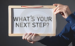 Man showing What`s Your Next Step? on small whiteboard