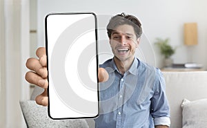 Man showing white empty smartphone screen close to camera