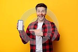 Man showing white empty smartphone screen and pointing finger
