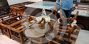 man showing wooden furniture at showroom for selling decorations item