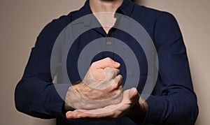 Man showing word CRUCIFY in sign language on color background