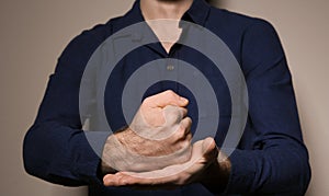 Man showing word CRUCIFY in sign language on color background photo