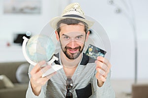 Man showing world-globe and credit card