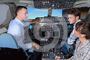 Man showing young people controls aircraft