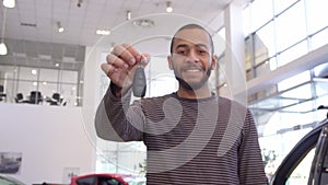 Man shows car key at the dealership