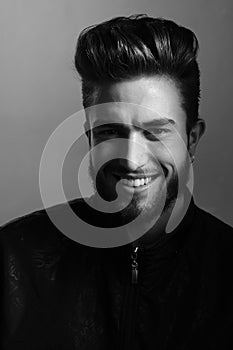 A man shows different human emotions. Close-up black and white portrait of a young handsome Caucasian male in studio.