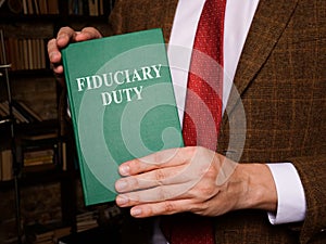 A man shows Fiduciary duty law book.