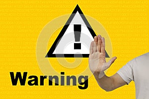 Man shows a hand on an exclamation mark on a triangle, concept attention on a yellow technological background, concept Deceptive