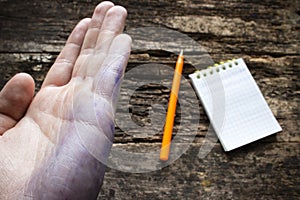 Man shows the problem lefties dirty hand after writing closeup