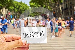 Man shows a signboard with the text Las Ramblas, at Las Ramblas photo