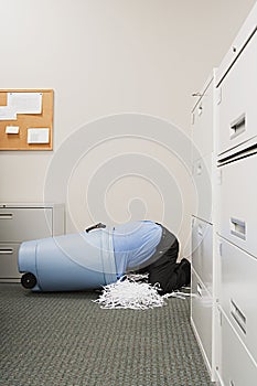 Man in shredded paper bin