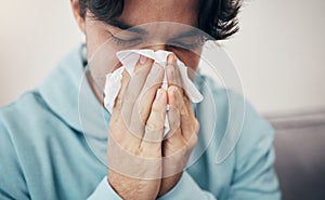 Man, sick and couch with tissue, sickness and virus for infection, sinus and cold symptoms. Sneeze, blowing nose and