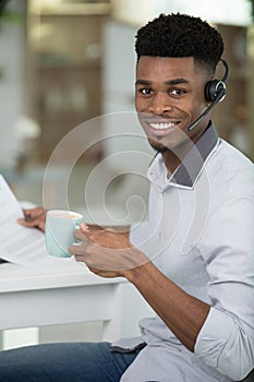 man in side profile smiling having online conversation