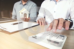 Man sign a home insurance policy on home loans, Agent holds loan photo