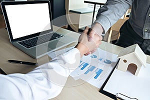 Man sign a home insurance policy on home loans, Estate agent shaking hands with his customer after contract signature, investment