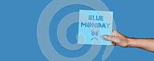 man with a sign with the text blue monday, banner