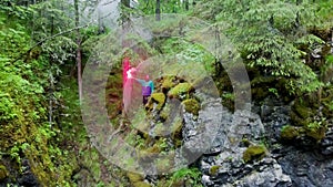 Man with signal fire in nature. Stock footage. Top view of lost traveler in forest and in despair he lit red smoke bomb