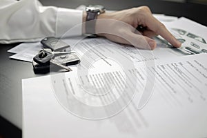 Man signing car insurance document or lease paper. Writing signature on contract or agreement. Buying or selling vehicle
