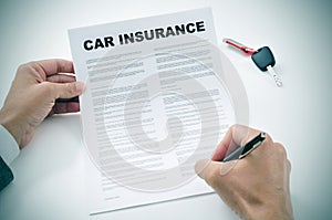 Man signing a car insurance policy