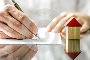 Man signing a contract when buying a new house