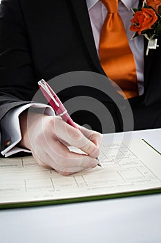 man signing a document