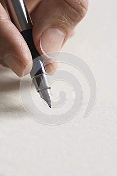 Man signing document close up of pen in hand