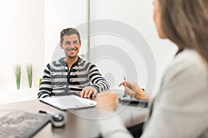 Man signing document in office