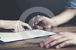 Man signing a document or writing correspondence