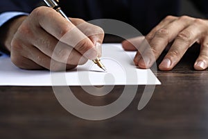 Man signing a document or writing correspondence photo
