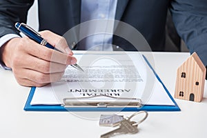 Man signing home contract documents. Contract agreement, real estate,  buy and sale and insurance concepts