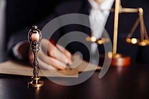 Man signing a Last Will and Testament document in notary public office. Stamp in focus