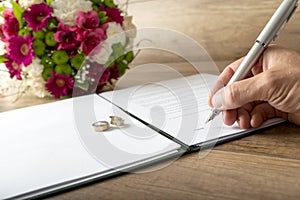 Man signing a marriage register