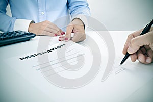 Man signing a resignation document