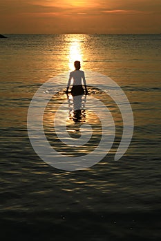 Man sihouette in the sea and sunrise