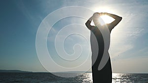 Man silhouette doing yoga exercise at sunset beach