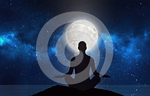 Man silhouette in moonlight, meditation under stars, full moon on night sky