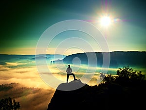 Man silhouette on the sharp peak. Satisfy hiker enjoy view.