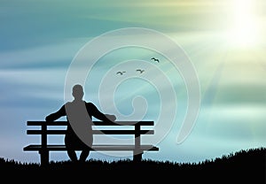 Man silhouette sitting alone on the bench at sunset and thinking